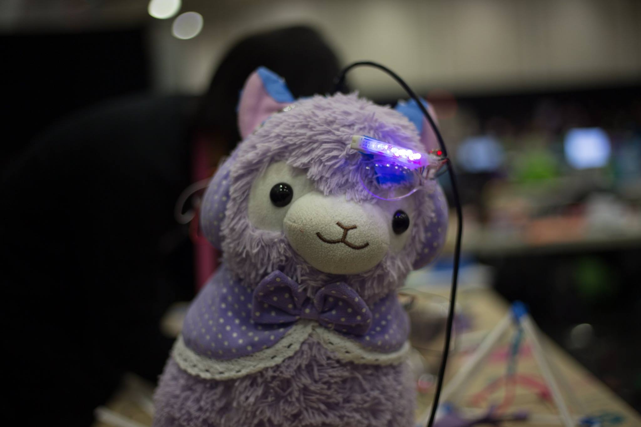 Technica 2018 Light the Way: A purple alpaca stuffed animal wearing a bowtie and a LED hardware hack.